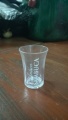 There are three of these shot glasses with writing.